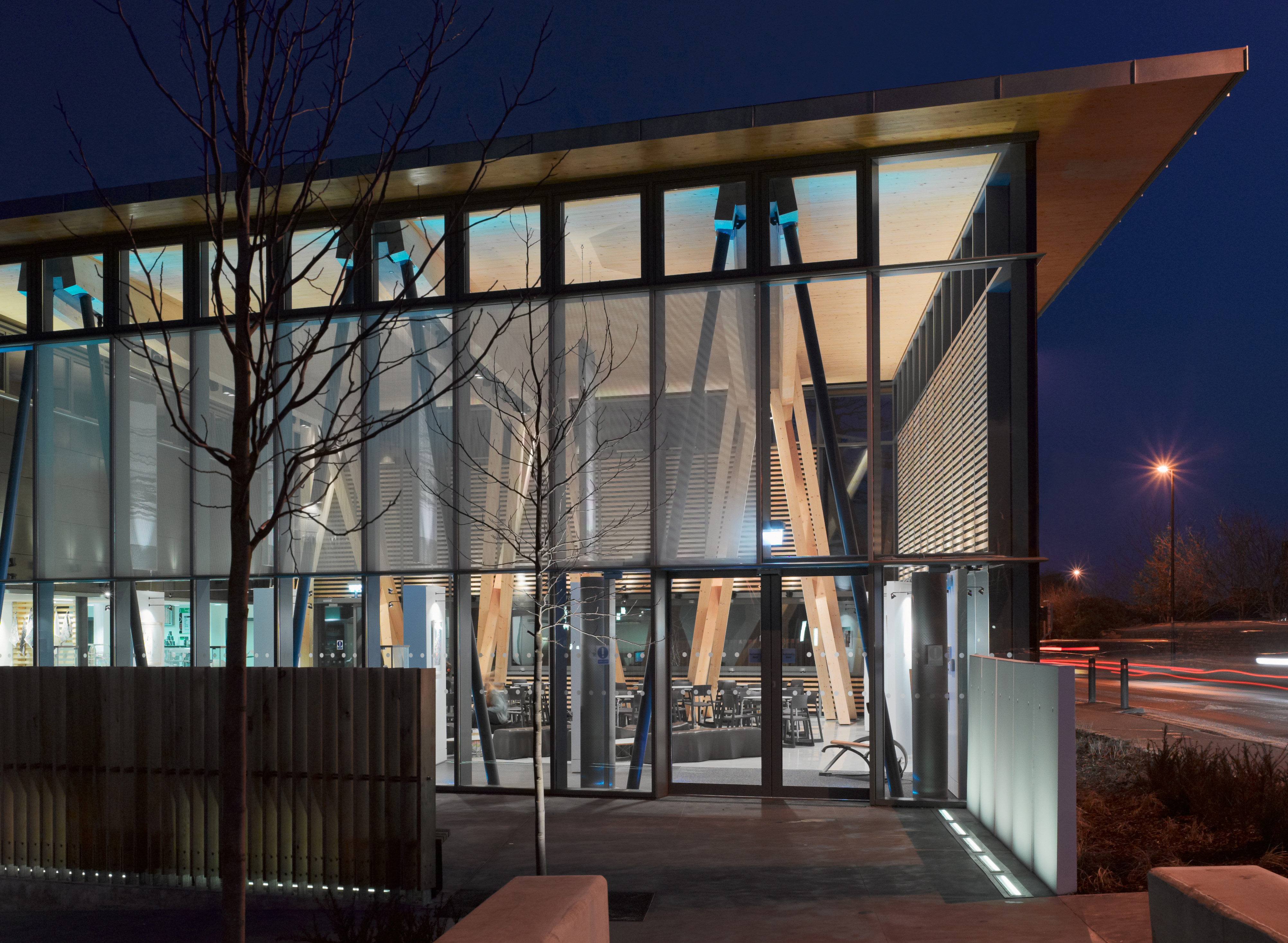 Night view entrance of HCA Arts Space with timber structure and led lighting.